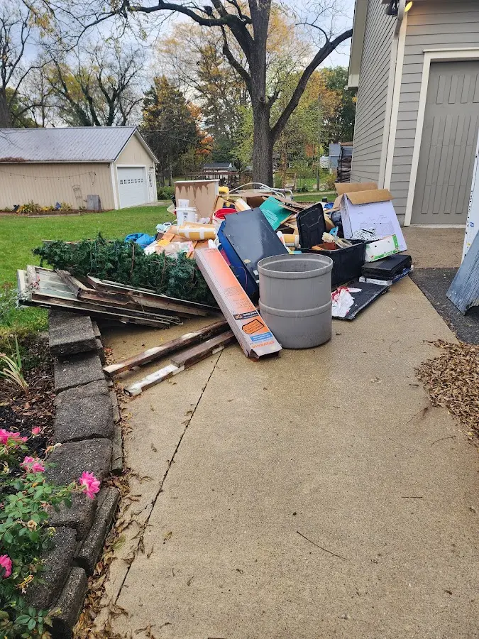 Dumpster being loaded with debris for 12 Yard Dumpster Rental in Sparta